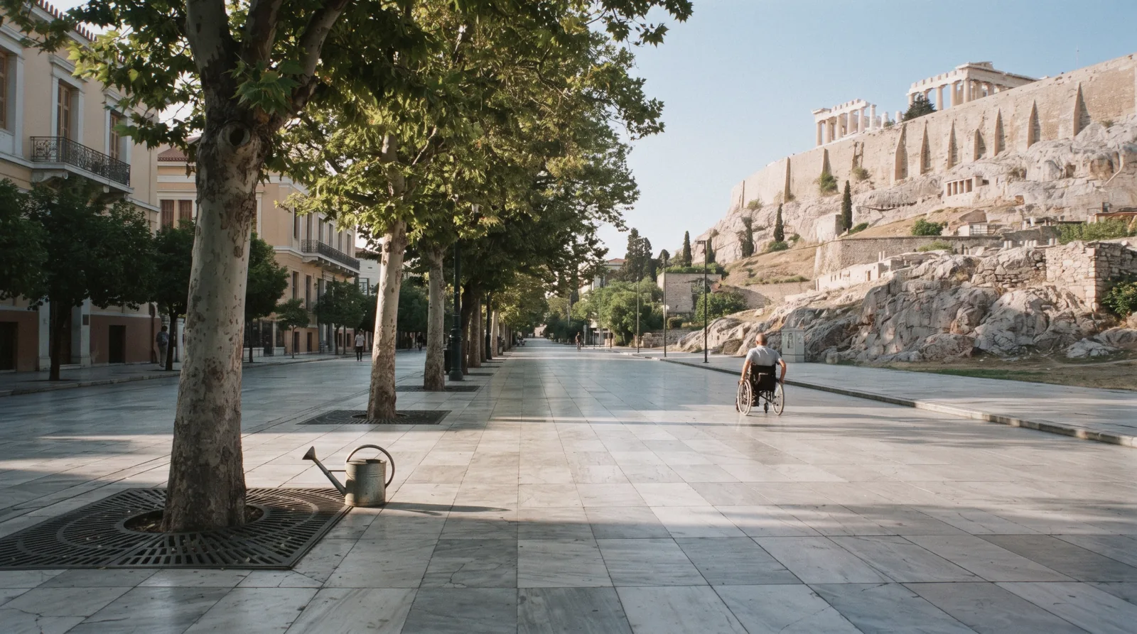 The wheelchair-accessible pedestrian marble of Dionysiou Areopagitou below the Acropolis, on an accessible visit to Athens, Greece