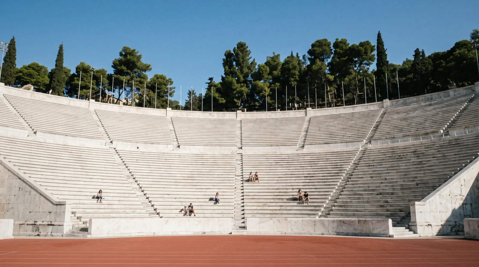 The white marble tiers of the Panathenaic Stadium in Athens, Greece, seen from the running track