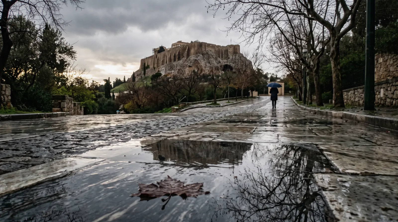 Wet marble paving on Dionysiou Areopagitou below the Acropolis after rain, on a rainy day in Athens, Greece