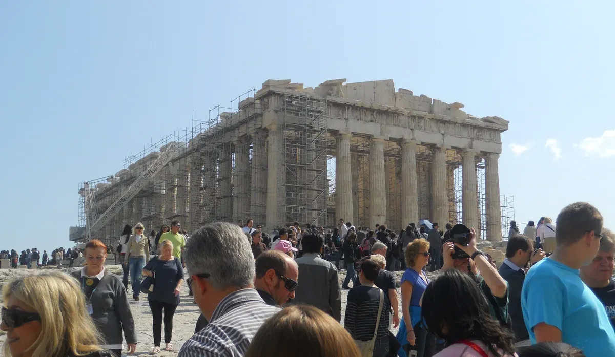 Visitors on the open rock of the Acropolis, which closes in the midday hours during Athens heatwaves, Greece